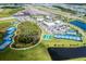 Aerial view of community amenities including pickleball and bocce ball courts, clubhouse and surrounding homes at 540 Good Life Way, Daytona Beach, FL 32124