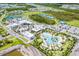 Aerial view of community amenities including pool, tennis courts, clubhouse, and parking area at 540 Good Life Way, Daytona Beach, FL 32124