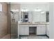 Bathroom featuring a glass shower, dual sinks, and granite countertops for a modern spa-like experience at 540 Good Life Way, Daytona Beach, FL 32124