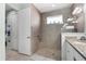 Bathroom with glass shower, granite vanity, and tile flooring; linen closet is conveniently located nearby at 540 Good Life Way, Daytona Beach, FL 32124
