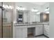 Bathroom featuring a glass shower, dual sinks, and granite countertops for a modern spa-like experience at 540 Good Life Way, Daytona Beach, FL 32124
