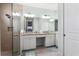 Bathroom featuring a glass shower, dual sinks, and granite countertops for a modern spa-like experience at 540 Good Life Way, Daytona Beach, FL 32124