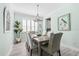 Bright dining room with light wood table, coastal decor, and shutters for a cozy, beachy ambiance at 540 Good Life Way, Daytona Beach, FL 32124