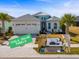 Beautiful single-Gathering home featuring solar panels, a two-car garage and tropical landscaping at 540 Good Life Way, Daytona Beach, FL 32124