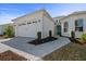 Charming single-Gathering home featuring a white exterior, two-car garage, and meticulously manicured landscaping at 540 Good Life Way, Daytona Beach, FL 32124
