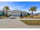 Well-maintained single Gathering home with palm trees, brick driveway, white exterior, and manicured landscaping at 540 Good Life Way, Daytona Beach, FL 32124