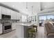 Kitchen with stainless steel appliances, an island with seating, and plenty of natural light at 540 Good Life Way, Daytona Beach, FL 32124