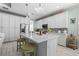 Bright kitchen island featuring white cabinets, stainless steel appliances, and pendant lighting at 540 Good Life Way, Daytona Beach, FL 32124