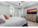 Spacious bedroom with a large TV, tray ceiling, and neutral tones, promoting relaxation and comfort at 540 Good Life Way, Daytona Beach, FL 32124