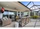 A beautiful covered patio with comfortable seating, a ceiling fan and views of the lake at 540 Good Life Way, Daytona Beach, FL 32124