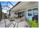 A gorgeous screened in patio with a ceiling fan and an outdoor TV set, perfect for entertaining at 540 Good Life Way, Daytona Beach, FL 32124