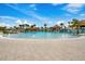 Large zero-entry pool with fountains, palm trees, and tiki huts, creating a tropical resort atmosphere at 540 Good Life Way, Daytona Beach, FL 32124