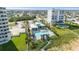 Resort-style pool area featuring a large pool, tiki huts, lounge chairs, and well-maintained landscaping at 540 Good Life Way, Daytona Beach, FL 32124