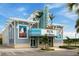Exterior of The Last Mango Theater, set in a tropical paradise with palm trees and vibrant colors at 540 Good Life Way, Daytona Beach, FL 32124