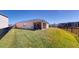Wide view of the backyard featuring lush lawn, a fenced perimeter, and a covered patio at 5431 Hutchinson St, Port Orange, FL 32128
