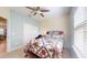 Comfortable bedroom with a full-sized bed, neutral carpeting, and bright, natural light from the window at 5431 Hutchinson St, Port Orange, FL 32128