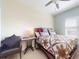 Cozy bedroom with a quilted bedspread, accent chair, and soft natural light from the window at 5431 Hutchinson St, Port Orange, FL 32128