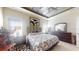Tranquil bedroom featuring a tray ceiling, comfortable queen bed, and ample natural light at 5431 Hutchinson St, Port Orange, FL 32128