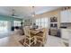 Inviting dining area featuring modern chandelier and flows seamlessly into the living room and kitchen at 5431 Hutchinson St, Port Orange, FL 32128