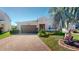 Charming single-story home with brick driveway, well-manicured landscaping and attached two-car garage at 5431 Hutchinson St, Port Orange, FL 32128
