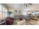 Bright living room featuring a sectional sofa, plantation shutters and seamless flow to the dining and kitchen areas at 5431 Hutchinson St, Port Orange, FL 32128