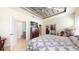 Spacious bedroom featuring a decorative tray ceiling, tile floors, dresser and walk-in closet at 5431 Hutchinson St, Port Orange, FL 32128