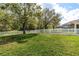 Lush backyard featuring a green lawn and a classic white picket fence at 6809 Plumpjack Ct, Port Orange, FL 32128