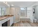 Well-lit bathroom featuring a glass shower, soaking tub, and dual sink vanity at 6809 Plumpjack Ct, Port Orange, FL 32128