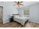 Inviting bedroom features wood-style flooring and a ceiling fan with lights at 6809 Plumpjack Ct, Port Orange, FL 32128