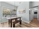 Cozy dining area features a rustic wood table and bench with great natural light at 6809 Plumpjack Ct, Port Orange, FL 32128