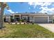 Charming home featuring manicured lawn, flower beds and a side-entry two-car garage at 6809 Plumpjack Ct, Port Orange, FL 32128