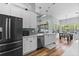 Bright kitchen features white cabinets, stainless steel appliances, and wood flooring at 6809 Plumpjack Ct, Port Orange, FL 32128