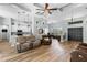 Inviting living room featuring hardwood floors, a tray ceiling, and an open floor plan at 6809 Plumpjack Ct, Port Orange, FL 32128