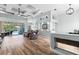 An open living area with wood floors and a sliding glass door leading to the pool at 6809 Plumpjack Ct, Port Orange, FL 32128