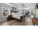 Spacious main bedroom with tray ceiling, wood floors, and ample natural light at 6809 Plumpjack Ct, Port Orange, FL 32128