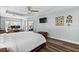 Bright main bedroom boasts wood floors, tray ceiling, and access to the outdoors at 6809 Plumpjack Ct, Port Orange, FL 32128