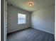 Well-lit bedroom featuring gray carpet, neutral paint, and a window at 1665 Lake Reserve Dr, Deland, FL 32724