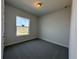 Cozy bedroom with gray carpet, a window for natural light, and neutral-colored walls at 1665 Lake Reserve Dr, Deland, FL 32724