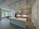 Spacious kitchen with a large center island, modern lighting, and an adjacent dining area at 1665 Lake Reserve Dr, Deland, FL 32724