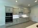 Well-equipped kitchen featuring sleek cabinetry, stainless steel appliances, and a herringbone backsplash at 1665 Lake Reserve Dr, Deland, FL 32724