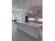 Bright kitchen featuring an island, modern appliances, stylish pendant lights, and dining area at 1665 Lake Reserve Dr, Deland, FL 32724
