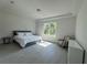 Serene main bedroom with large windows, tile floors, and a light and airy ambiance at 1665 Lake Reserve Dr, Deland, FL 32724