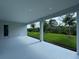 Covered patio overlooking a lush green lawn and trees at 1665 Lake Reserve Dr, Deland, FL 32724