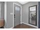 Welcoming entryway features a stylish gray front door with decorative glass and a full length mirror at 1836 Biscayne Ave, South Daytona, FL 32119