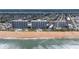 Stunning aerial view of beachfront condos, oceanfront living, and a pristine beach at 1155 Ocean Shore Blvd # 702, Ormond Beach, FL 32176