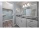 Bathroom with granite countertop, white vanity, and closet access at 1155 Ocean Shore Blvd # 702, Ormond Beach, FL 32176
