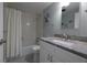 Bathroom with patterned floor tiles, shower, and vanity with granite countertop at 1155 Ocean Shore Blvd # 702, Ormond Beach, FL 32176
