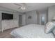 Bedroom with wood floors and a dresser with a TV on top at 1155 Ocean Shore Blvd # 702, Ormond Beach, FL 32176