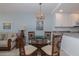 Cozy dining area with stylish lighting and seating, seamlessly connected to the kitchen and living room at 1155 Ocean Shore Blvd # 702, Ormond Beach, FL 32176