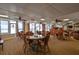 A condo's dining area overlooking a beach with wicker seating, tables and ceiling fans at 1155 Ocean Shore Blvd # 702, Ormond Beach, FL 32176